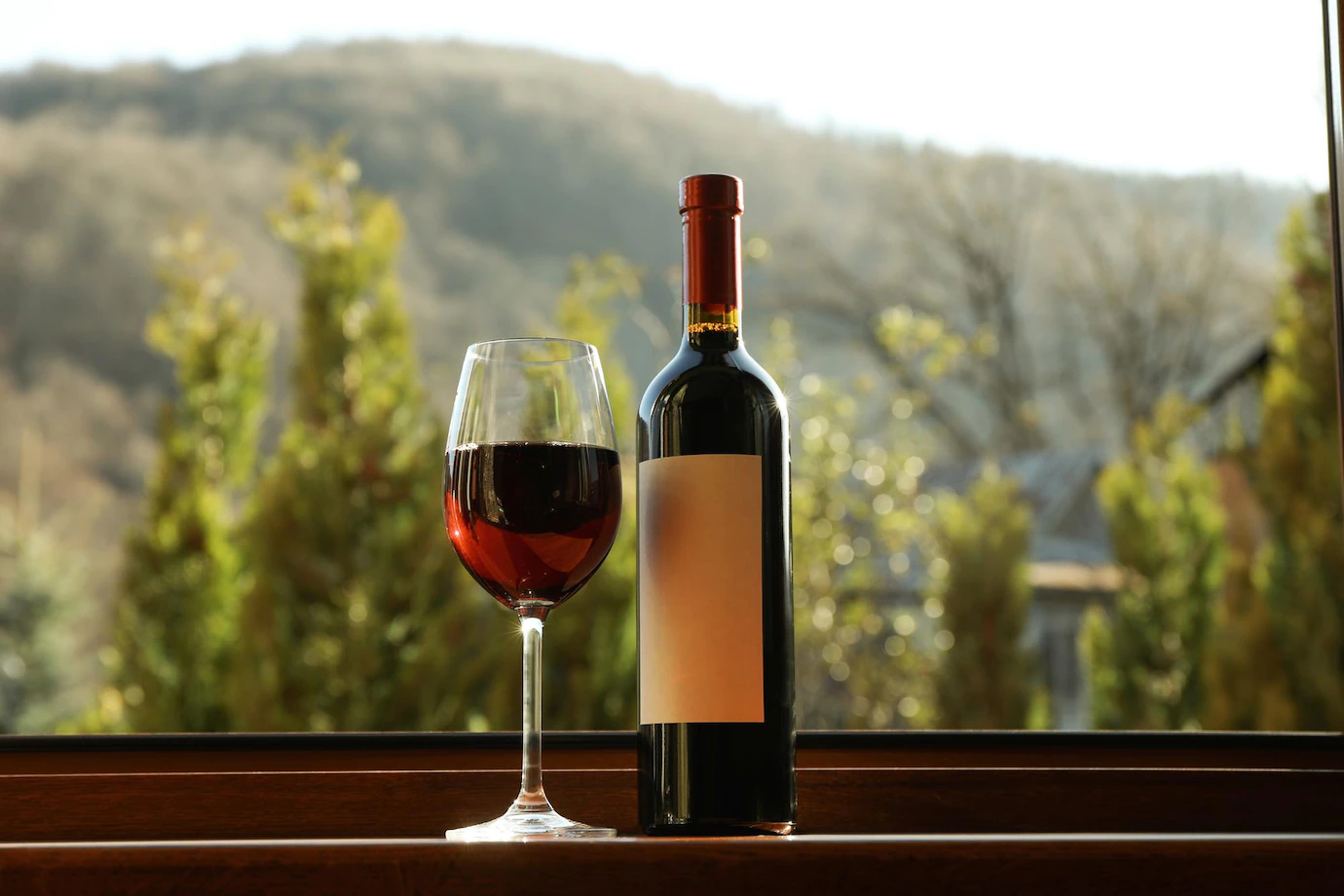 glass-bottle-wine-stands-wooden-windowsill_185193-81992.jpg